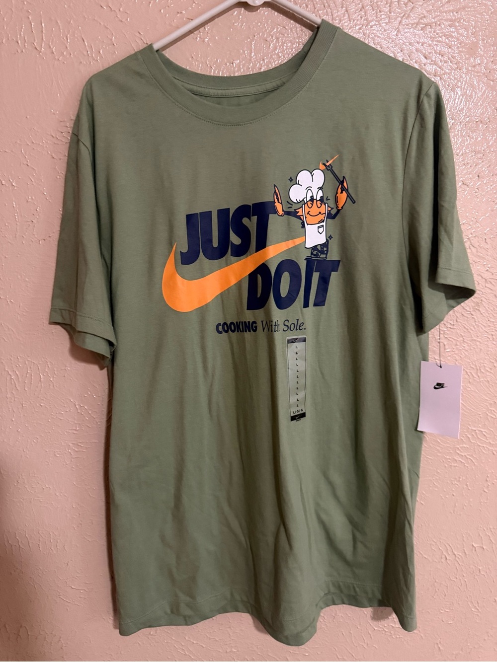 Nike Olive Green Short-Sleeve Graphic Tee with Navy Text and Orange Swoosh